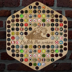 May include: Wooden bottle cap display in a hexagonal shape, featuring a laser-cut wave design and the phrase "Catch the wave." The display is filled with various colorful bottle caps and is mounted on a brick wall.