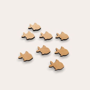 May include: Nine wooden fish cutouts in a light brown color. The fish are arranged in a staggered pattern on a white background.