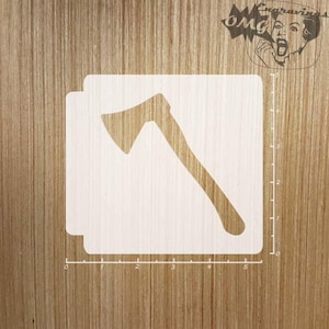 May include: A white stencil of an axe, measuring 12.7 cm in length, on a woodgrain background.