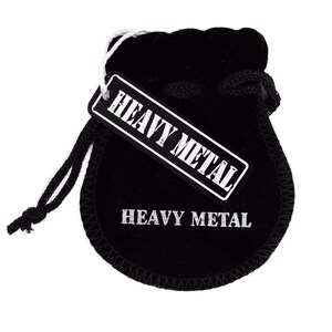 May include: Black velvet pouch with a white drawstring and a white tag that says "Heavy Metal". The pouch also has the words "Heavy Metal" printed on the front.