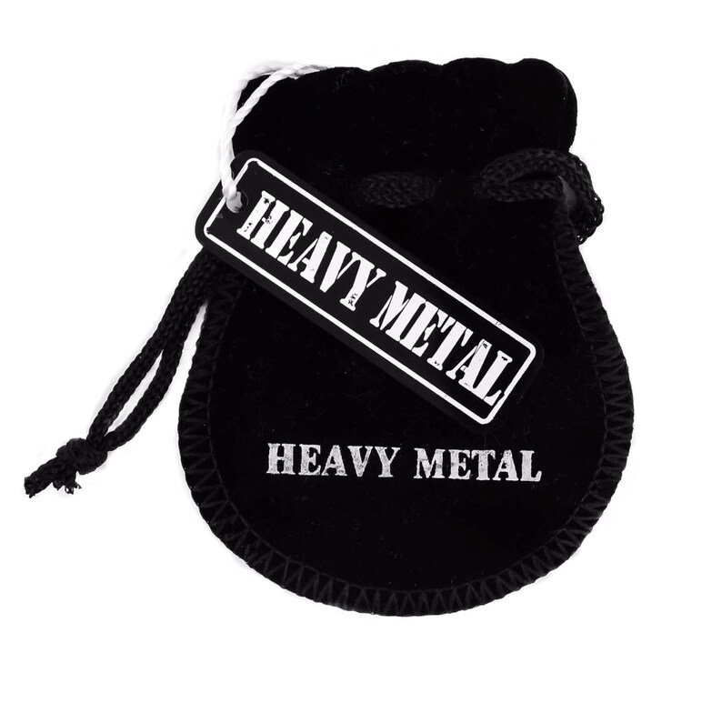 May include: Black velvet pouch with a white drawstring and a white tag that says "Heavy Metal". The pouch also has the words "Heavy Metal" printed on the front.