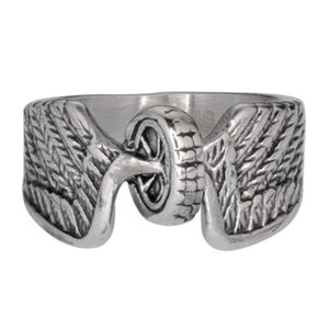 May include: A silver ring with a motorcycle wheel design and wings on either side.