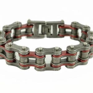 May include: A silver and red metal bracelet made of linked chains. The bracelet has a brushed metal finish and a red accent on each link.