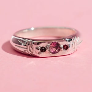 Pink tourmaline and red garnet band ring with two evil eyes