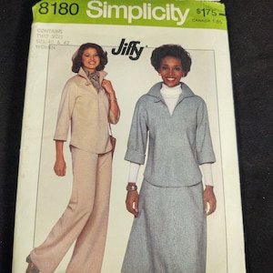 May include: Simplicity sewing pattern number 8180 for women's clothing. The pattern contains two sizes, 40 and 42. The pattern shows two women wearing different outfits. One woman is wearing a brown jacket and pants. The other woman is wearing a white and blue checkered top and skirt. The pattern is called "Jiffy" and is priced at $1.75.