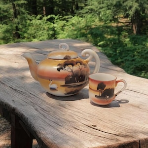 Tetera y taza Takito vintage pintadas a mano con forma de cisne en el lago al atardecer