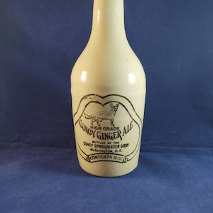 May include: A vintage glass bottle with a label that reads "High Grade Gomoy Ginger Ale" and "Bottled by the Concy Springwater Corp. Washington, D.C. Contents 12 oz."