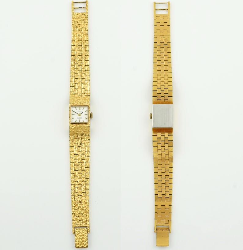 May include: Two gold-toned wristwatches. One watch features a square face with Roman numeral hour markers and a textured gold band. The other watch has a rectangular silver face and a gold band with a different textured pattern.