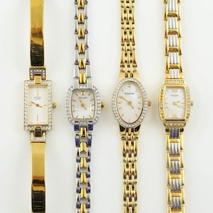May include: Four gold and silver tone wristwatches with crystal accents. The watches are arranged from left to right: Citizen Quartz, Pulsar, Accuriet, and Pulsar.