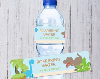 May include: Water bottle label with a blue background and a dinosaur illustration. The label says "Roarrrring Water PJ's 3rd Birthday".