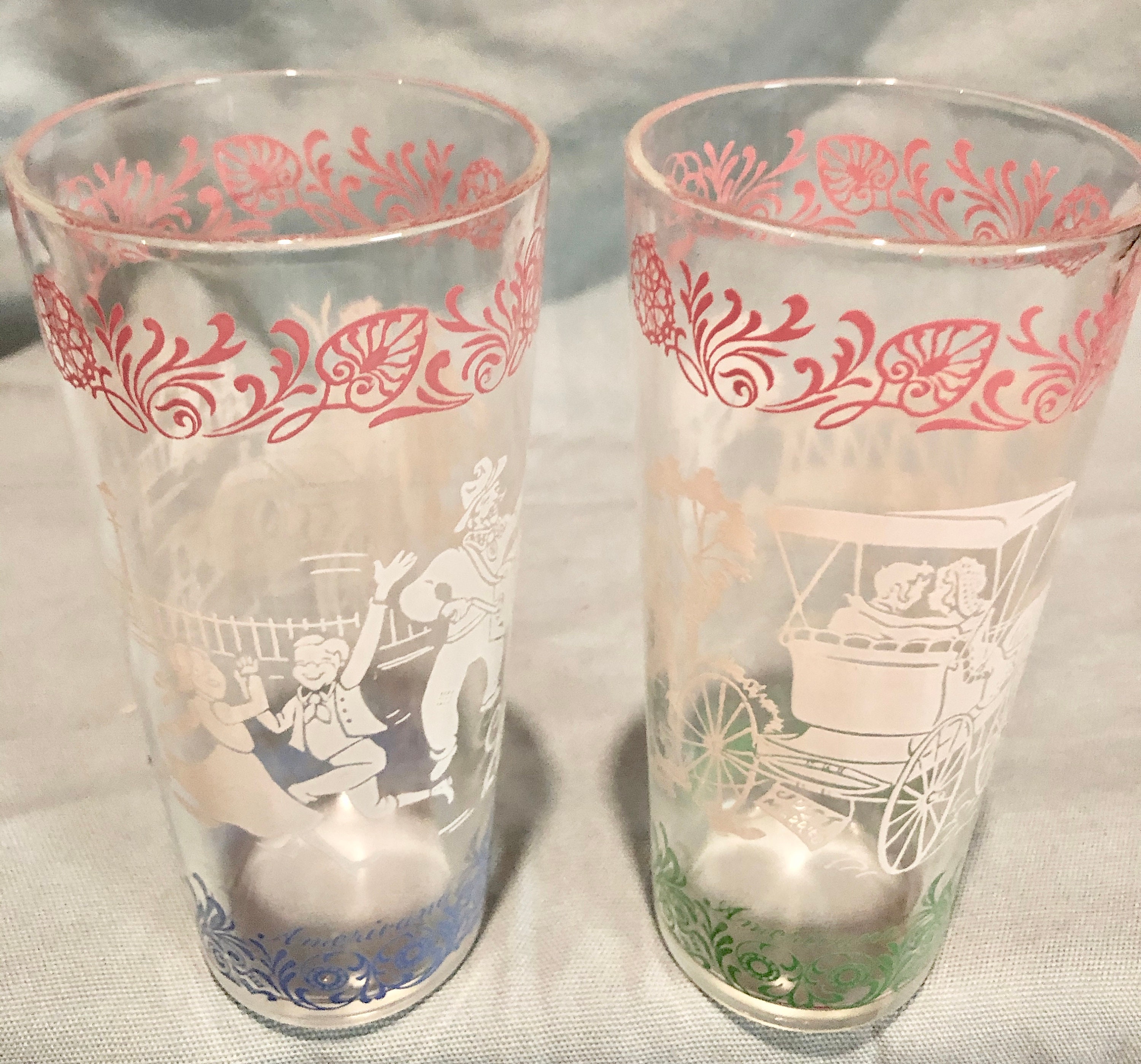 This set of two Americana beverage tumblers/glasses depict lively scenes in...