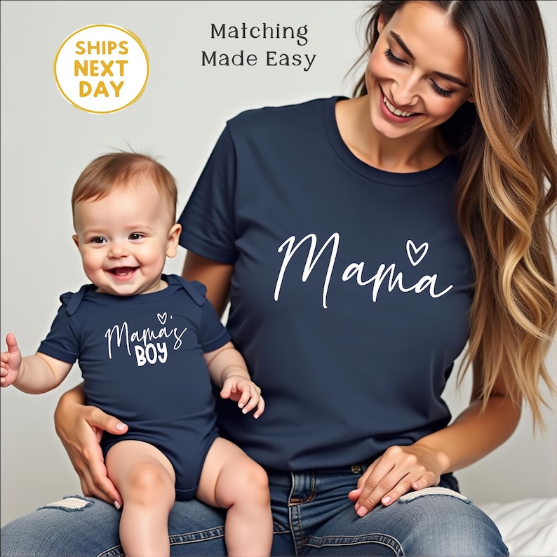May include: Navy blue t-shirt with the word "Mama" and a heart graphic. A baby in a navy blue onesie with the words "Mama's Boy" is held by a person. The image includes the text "Matching Made Easy" and "SHIPS NEXT DAY".