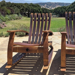 Repurposed Wine Barrel Rocking Chairs with dark red wine stain. The soft cradling Oak barrel Rocking chairs are coated with a protective oil that enhances the oak barrel colors.