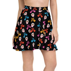 May include: A black skater skirt with a colorful skull and crossbones pattern. The skirt is made of a soft, stretchy fabric and has a comfortable fit.