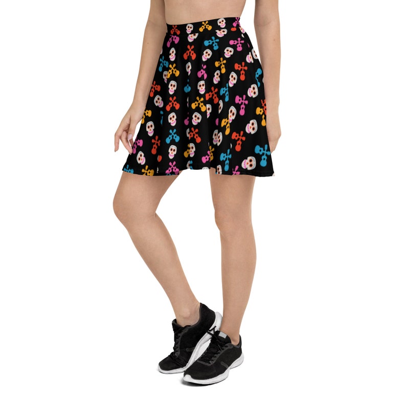 May include: A black skater skirt with a colorful skull pattern. The skirt is made of a soft, stretchy fabric and has a comfortable fit.