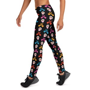May include: Black leggings with a colorful skull and crossbones pattern. The skulls are wearing sombreros and have colorful accents.