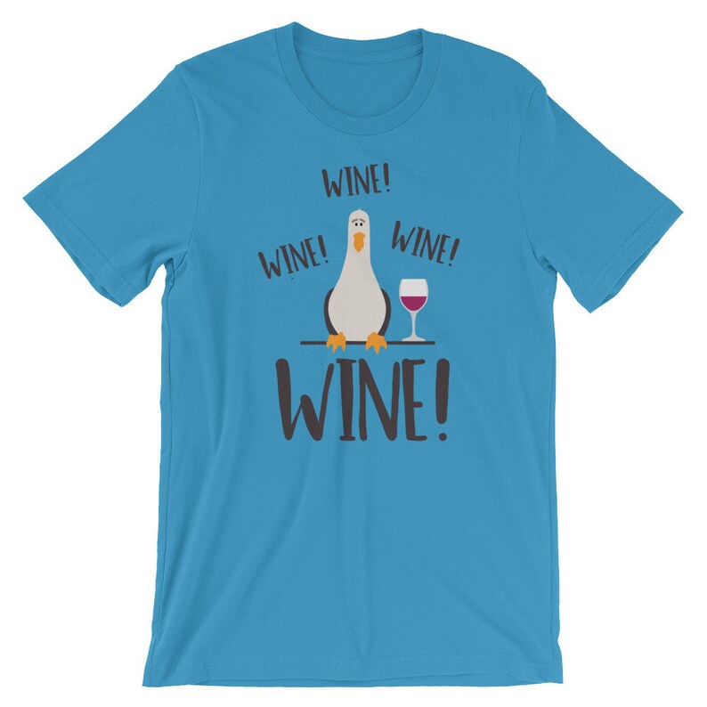 May include: A turquoise blue t-shirt featuring a cartoon seagull holding a glass of wine. The text "WINE!" is repeated four times on the shirt.
