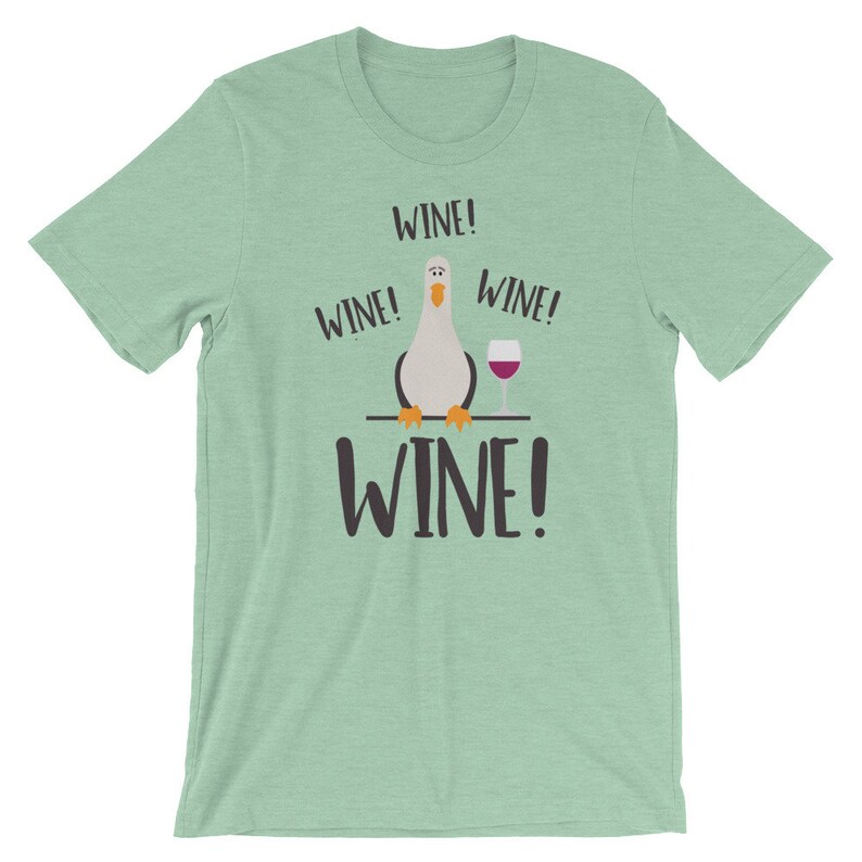 May include: A light green t-shirt featuring a cartoon seagull and the text "WINE!" repeated four times.
