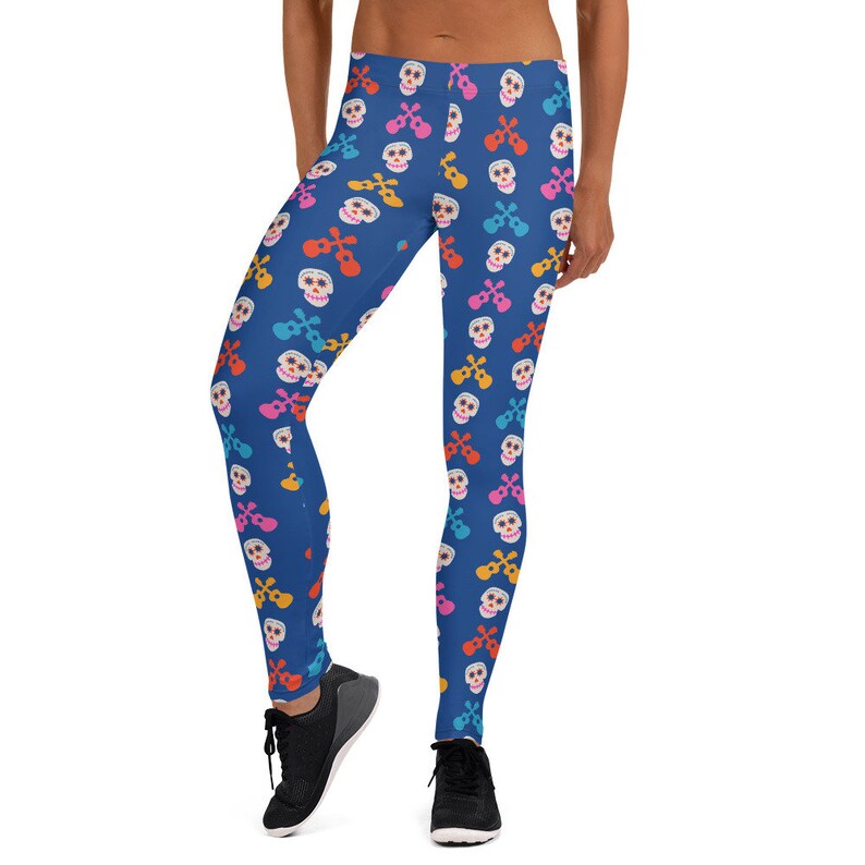 May include: Blue leggings with a colorful skull and ukulele pattern.