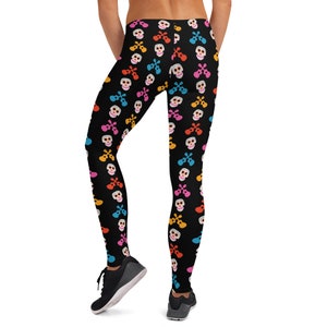 May include: Black leggings with a colorful pattern of skulls and guitars. The skulls are white with colorful accents and the guitars are yellow, blue, pink, and orange.