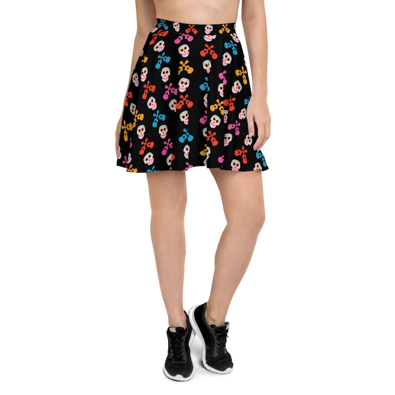 May include: A black skater skirt with a colorful skull and crossbones pattern. The skirt is made of a soft, stretchy fabric and has a comfortable fit.
