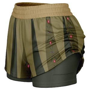 May include: Green and brown striped athletic shorts with a pink and blue geometric pattern. The shorts have a black waistband and a black inner layer.
