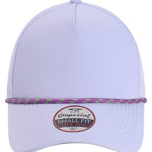 May include: A light purple baseball cap with a curved brim. The cap features a purple and green rope detail and a circular patch with the text "Imperial SMALL FIT UPF 50+" and "SINCE 1916".