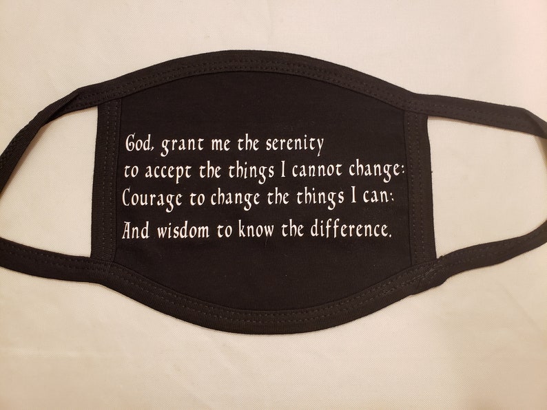 May include: Black face mask with white embroidered text. The text reads: "God, grant me the serenity to accept the things I cannot change: Courage to change the things I can: And wisdom to know the difference."