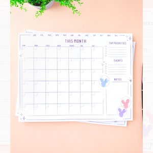 May include: A printable monthly planner with a calendar grid, sections for top priorities, events, and notes, and a whimsical Mickey Mouse balloon design.