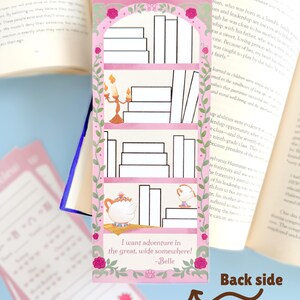 May include: A pink bookmark with a bookshelf design, featuring a teapot, teacup, and candelabra illustrations. The bookmark has the quote "I want adventure in the great, wide somewhere!" and is surrounded by roses.