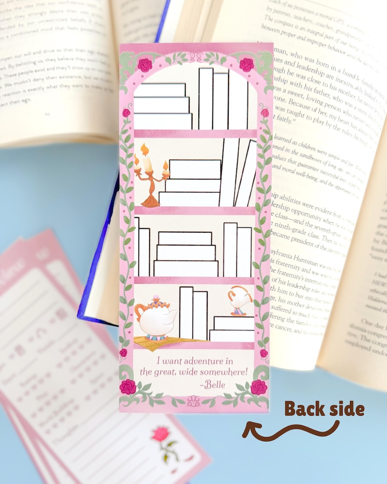 May include: A pink bookmark with a bookshelf design, featuring a teapot, teacup, and candelabra illustrations. The bookmark has the quote "I want adventure in the great, wide somewhere!" and is surrounded by roses.