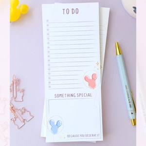 May include: A white to-do list notepad with a pink and blue Mickey Mouse balloon illustration. The notepad has a section for "Something Special" with the text "Because you deserve it".