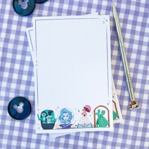 Puede incluir: Un bloc de notas blanco sobre un fondo de cuadros azules y blancos. El bloc de notas tiene un borde negro y un borde decorativo de personajes de una pel&iacute;cula de Disney. Los personajes incluyen una mujer con cabello azul, una mujer con un vestido rosa y dos hombres con trajes verdes.