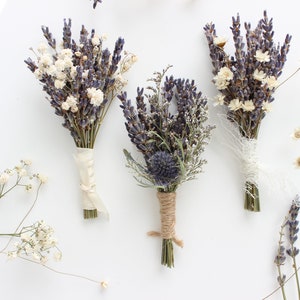 May include: Three small bouquets of dried lavender, baby's breath, and other dried flowers tied with twine and ribbon.