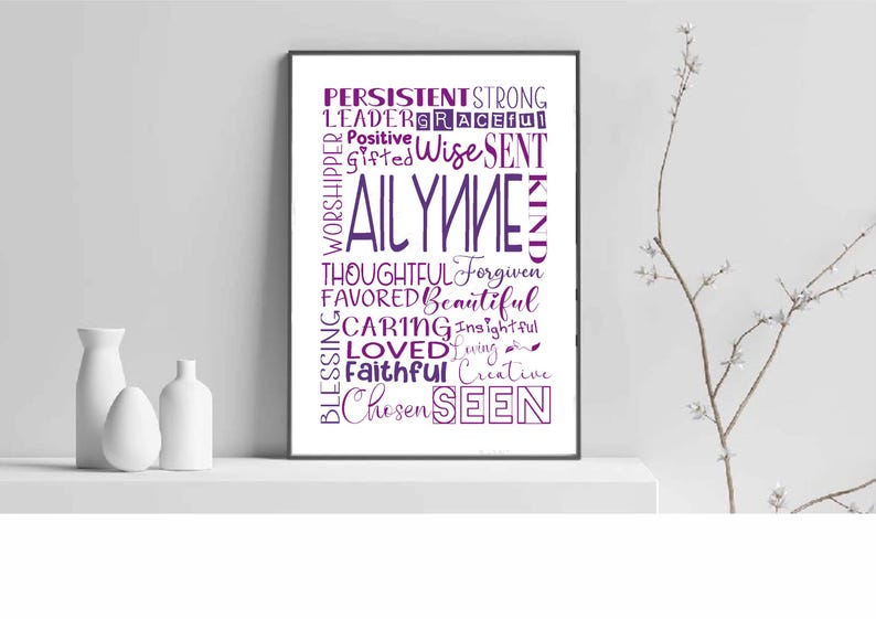 May include: A framed print with the name "AILYNNE" in large purple letters, surrounded by positive words like "Chosen", "Loved", and "Beautiful". The print is displayed on a white shelf with three white decorative vases.