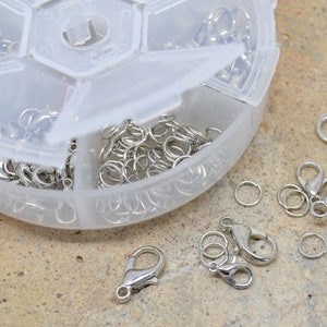 70 clasps, 70 junction rings, silver metal, plastic storage box, mix assortment