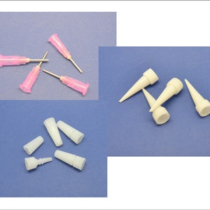 May include: A set of five pink and white plastic dispensing tips for glue, epoxy, or other adhesives. The tips are designed for precision application and come in a variety of sizes.