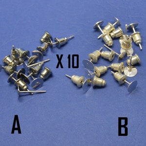 Puede incluir: Dos grupos de postes de pendientes de plata, etiquetados como A y B. El grupo A tiene 17 postes, el grupo B tiene 10 postes. El texto "X 10" es visible en la imagen.