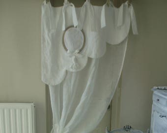 Beautiful festoon curtain good woman. In old linen and linen veil. Ponpon and monogram