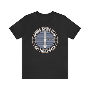 May include: Black t-shirt with a white circle graphic featuring a spine, the text "Bionic Spine Club", and "Custom Parts".