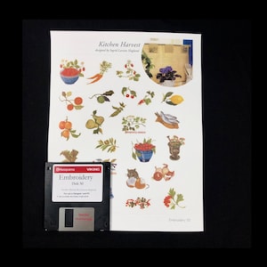 May include: A black floppy disk labeled "Embroidery Disk 50" with the text "Kitchen Harvest designed by Ingrid Larson Hagland" and a variety of colorful embroidery designs for kitchen-themed items.