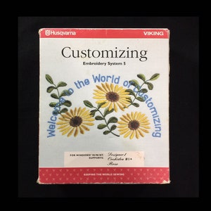 May include: A box for a Husqvarna Viking embroidery system. The box is red and white with a yellow and blue floral design. The text on the box reads "Customizing Embroidery System 5" and "Welcome to the World of Customizing".