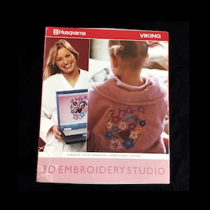 May include: A Husqvarna Viking 3D Embroidery Studio box shows a woman with a laptop displaying a heart design. The box also shows a child wearing a pink jacket with a floral heart design. The text reads "CREATE YOUR PERSONAL EMBROIDERY VISION."