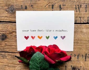 your love feels like a rainbow compliment greeting card in typewriter font with rainbow hearts, envelope and rose sticker, LGBTQ pride card