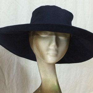 May include: A wide-brimmed navy blue sun hat with a slightly curved crown.