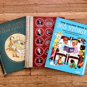 May include: Three vintage hardcover books titled Nursery Friends from France, The Golden Book of America, and The Golden Book of 365 Stories. The books feature illustrated covers in teal, red, and light blue with various character designs.