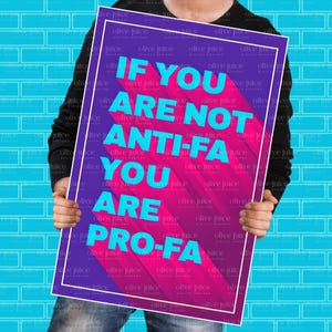 以下が含まれることがあります： 紫とピンクの背景に、ターコイズ色の「IF YOU ARE NOT ANTI-FA YOU ARE PRO-FA」というテキストが書かれたポスター。青いレンガの壁を背景に、人がポスターを持っています。