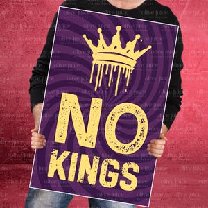 May include: A purple poster with a yellow crown graphic and the words "NO KINGS" in large yellow letters. The background has a radial design. The poster is held by a person.