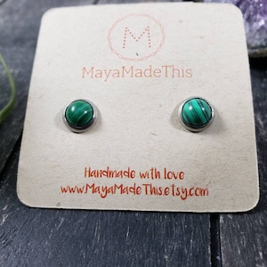 May include: A pair of silver stud earrings with green malachite stones. The earrings are on a card that says "MayaMadeThis" and "Handmade with love www.MayaMadeThis.etsy.com".