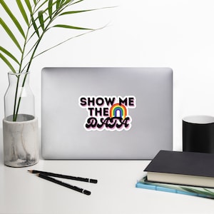 May include: A laptop computer with a sticker that says "Show Me The Data" with a rainbow graphic.